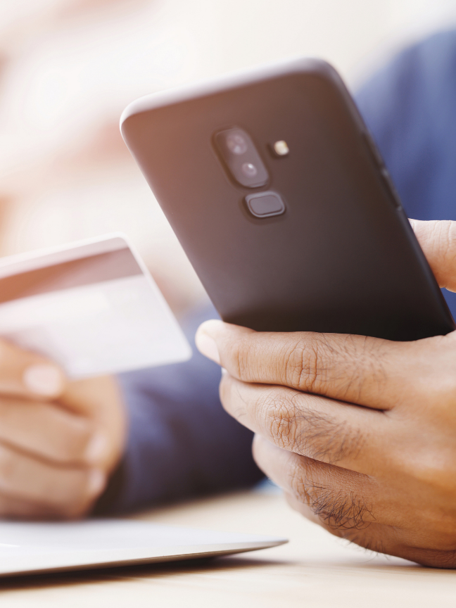 Man holding a Phone and a credit card